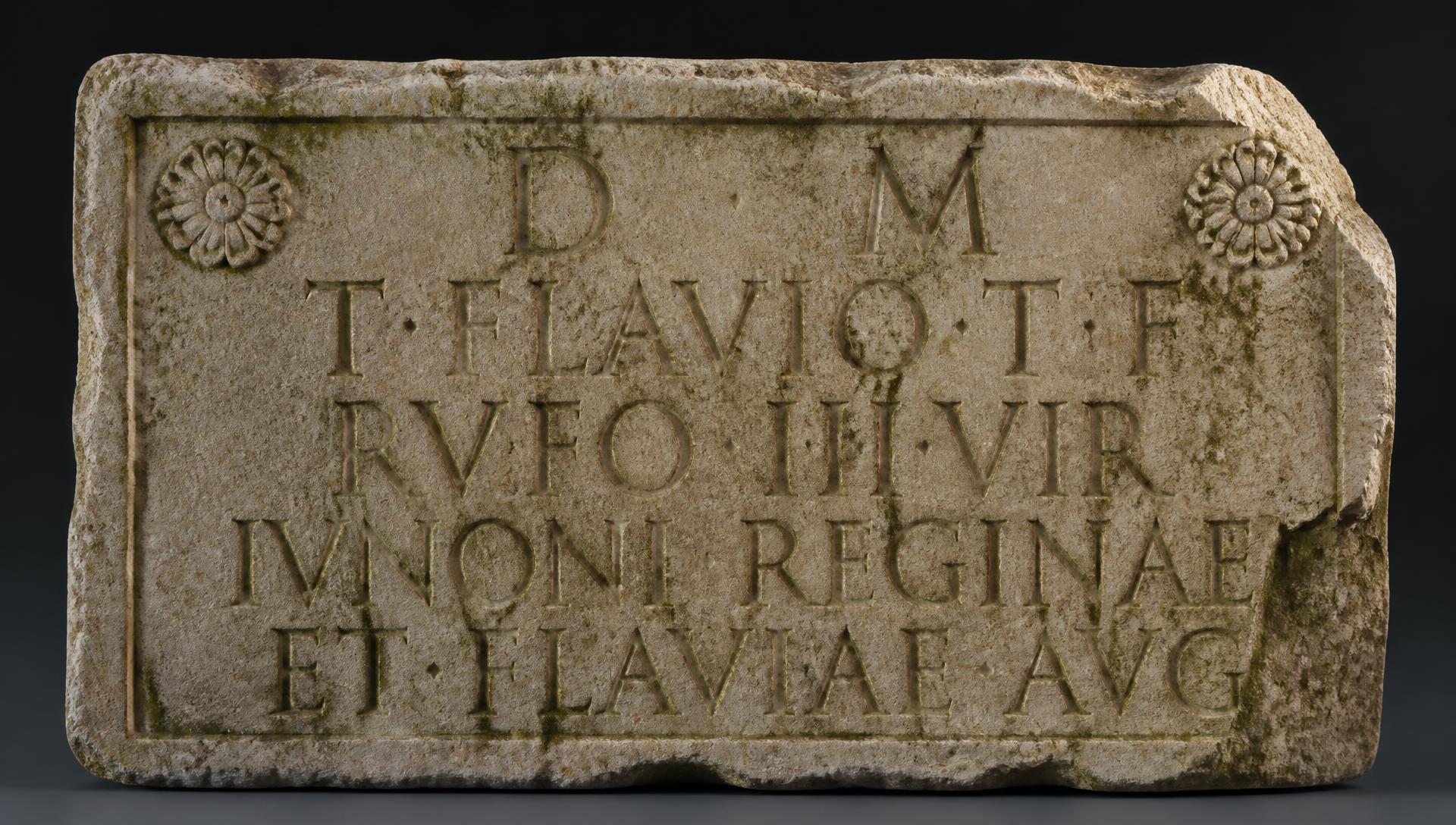 A weathered Roman stone inscription carved in Latin capitals